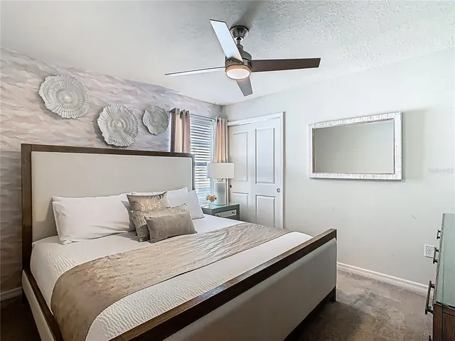 a bedroom with a large bed and a window