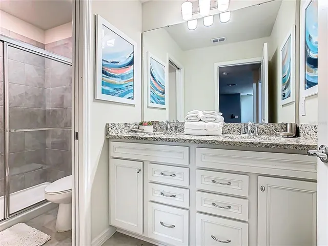 a bedroom with a bed and a flat tv screen