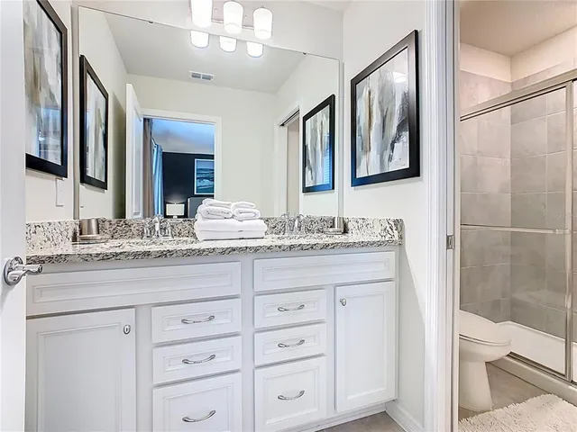 a bedroom with a bed and ceiling fan