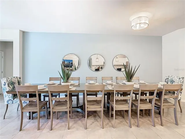 a kitchen with stainless steel appliances kitchen island granite countertop a table and chairs in it