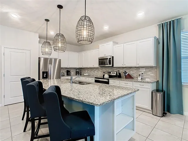 a kitchen with stainless steel appliances granite countertop a stove and a microwave