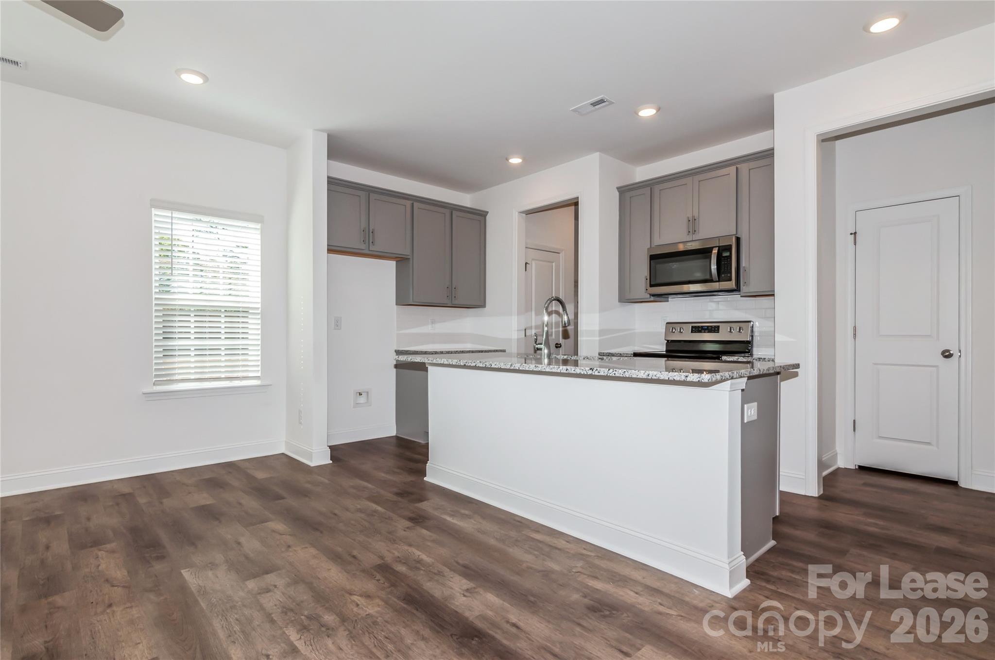 6002 Cedar Chip Way Matthews, NC 28105 - Photo 12 of 35 a kitchen with a refrigerator and a stove top oven