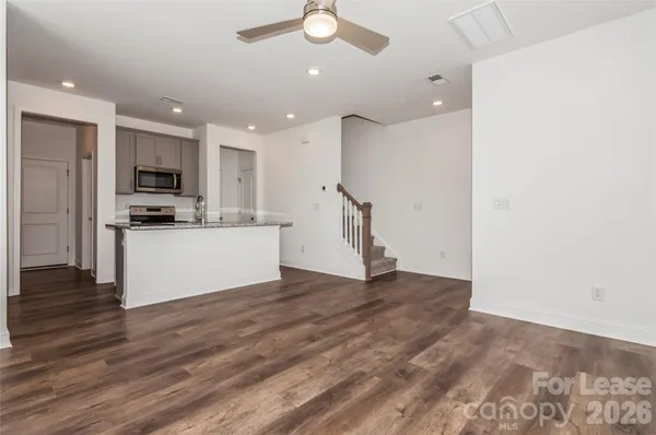a view of a kitchen with a sink and a refrigerator