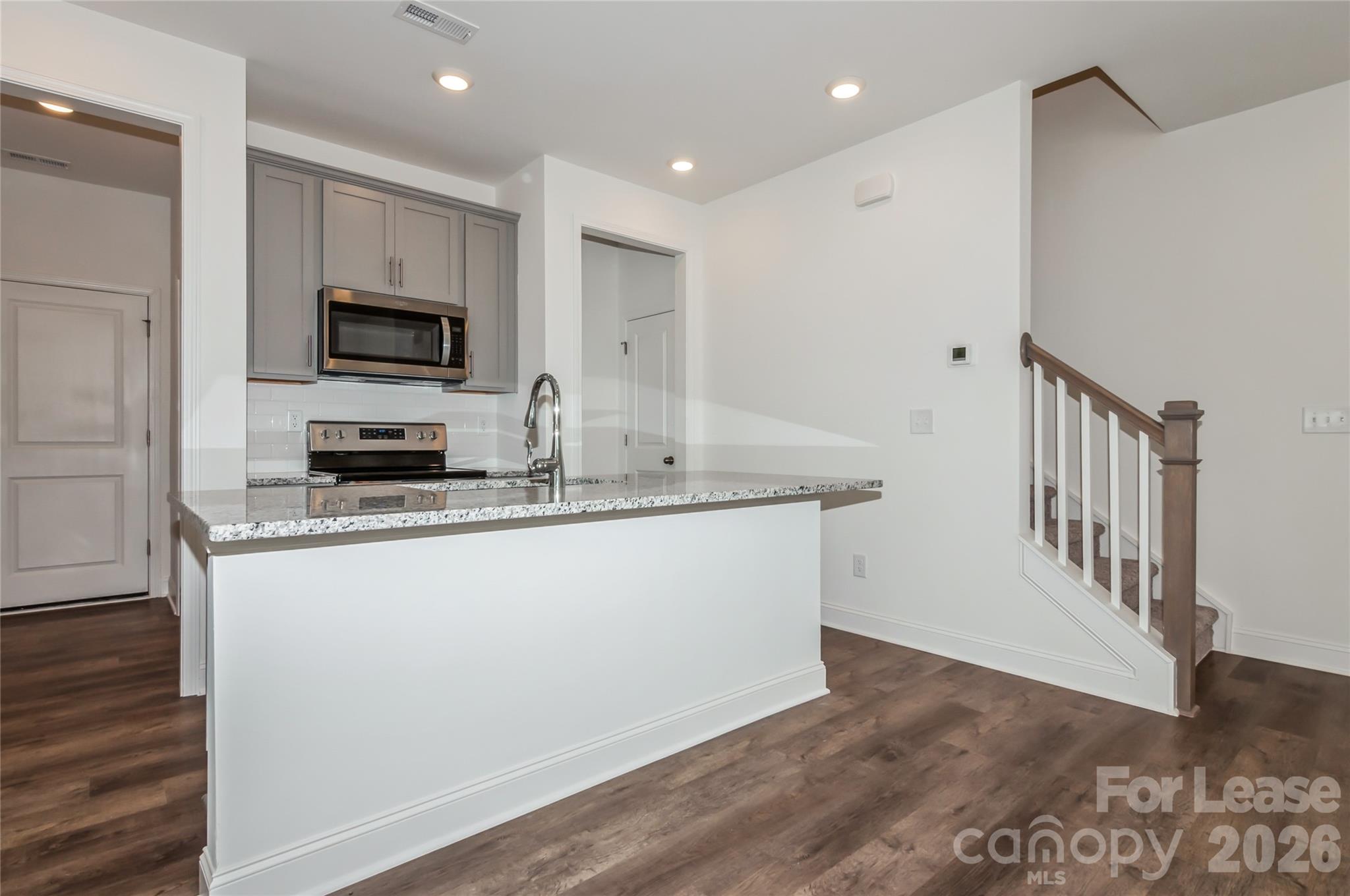 6002 Cedar Chip Way Matthews, NC 28105 - Photo 14 of 35 a kitchen with stainless steel appliances granite countertop a stove a sink and a refrigerator