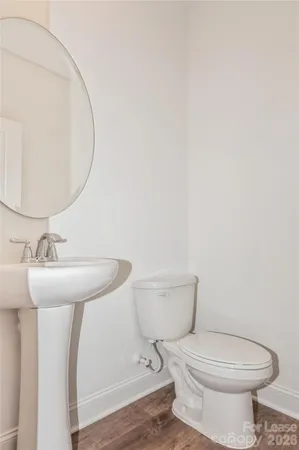 a bathroom with a toilet a sink and a mirror