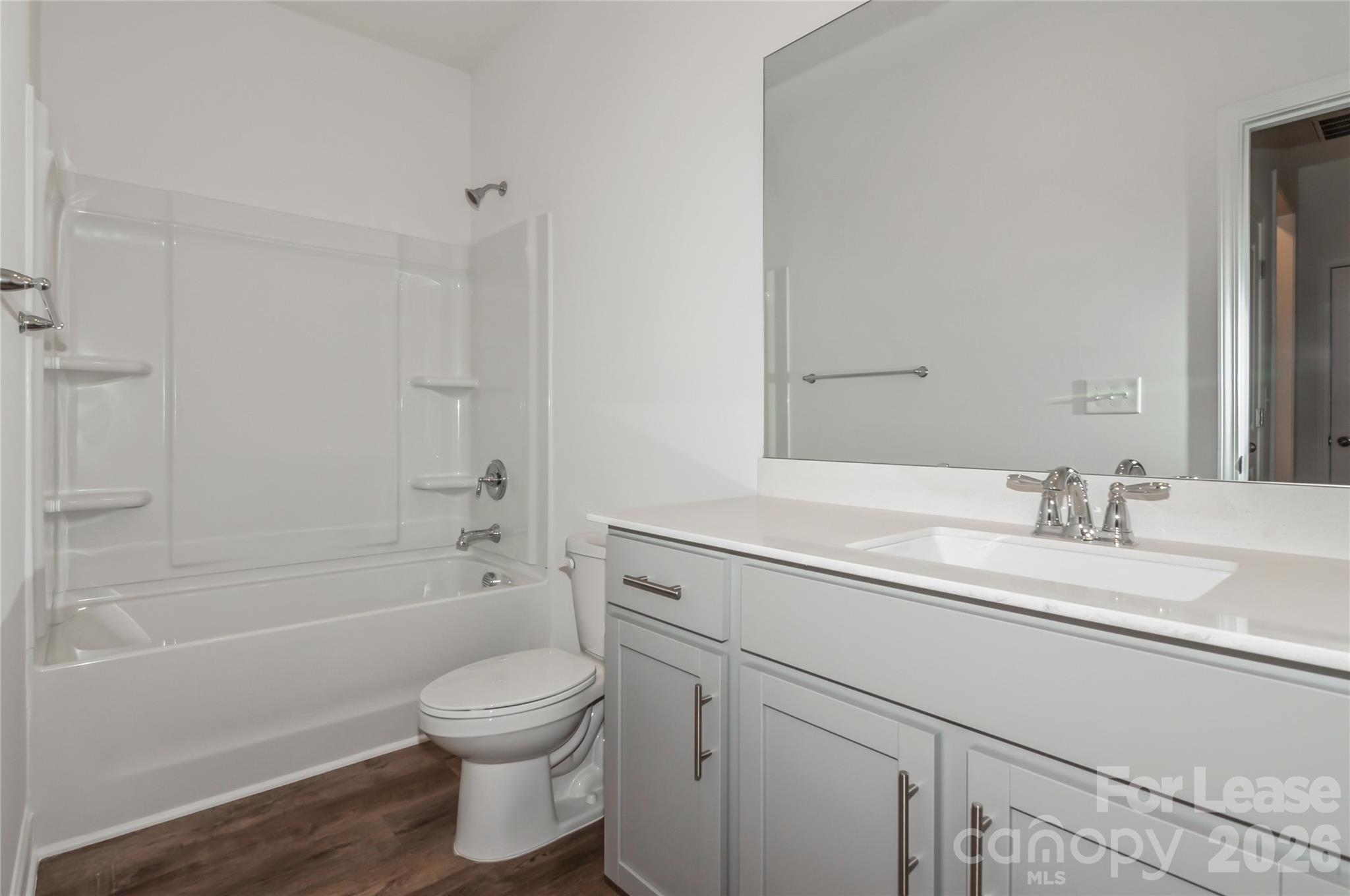 6002 Cedar Chip Way Matthews, NC 28105 - Photo 22 of 35 a bathroom with a granite countertop sink a toilet and shower