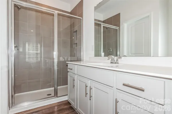 a bathroom with a shower sink and mirror
