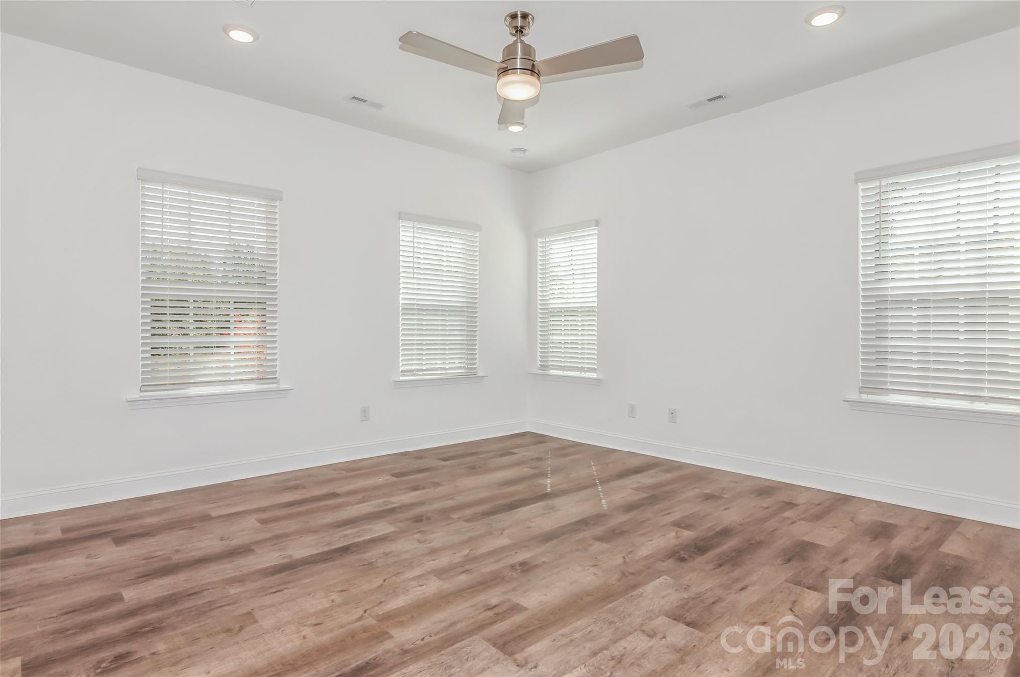 6002 Cedar Chip Way Matthews, NC 28105 - Photo 5 of 35 a view of empty room with wooden floor and fan