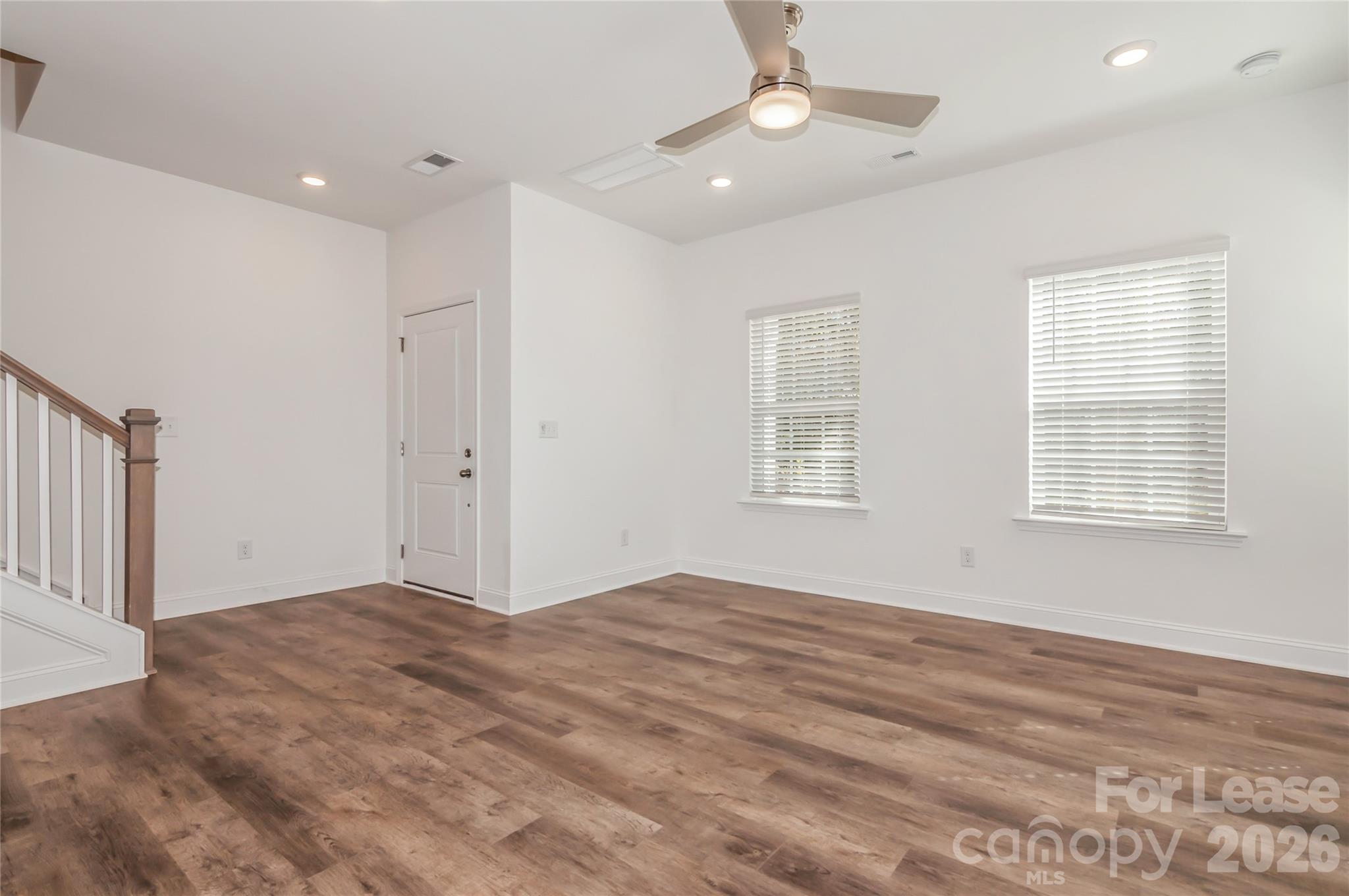 6002 Cedar Chip Way Matthews, NC 28105 - Photo 9 of 35 an empty room with windows and ceiling fan
