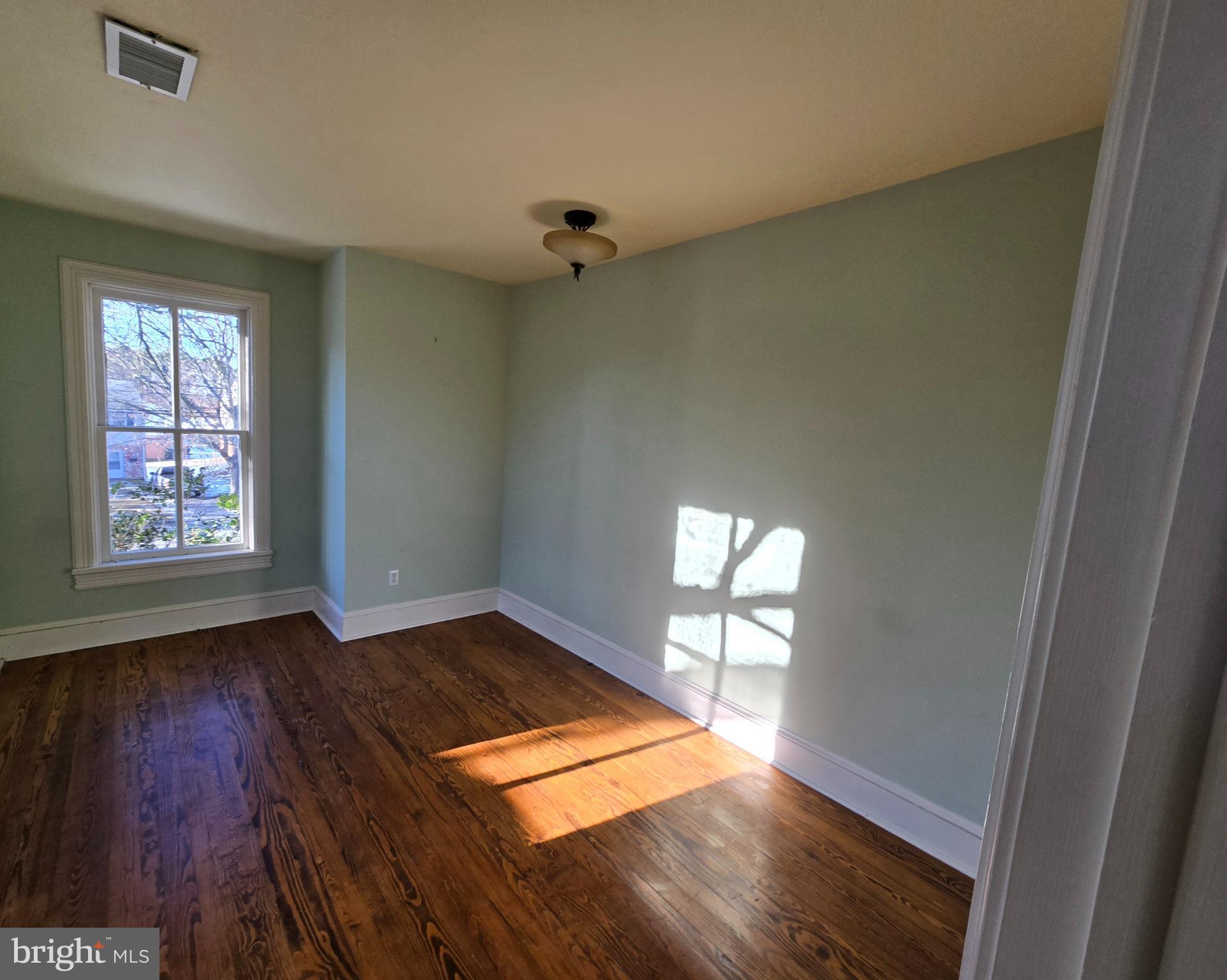 101 Chapel Road Easton, MD 21601 - Photo 14 of 35 wooden floor in an empty room with a window