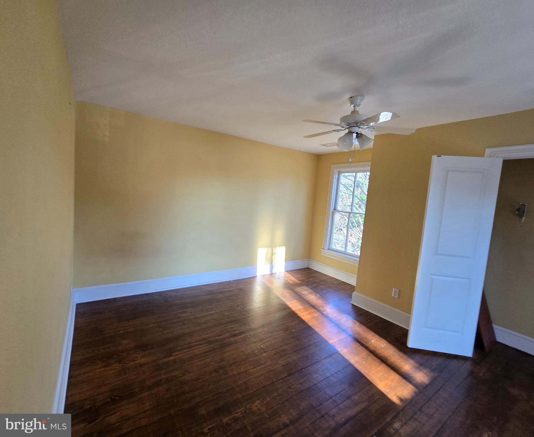 101 Chapel Road Easton, MD 21601 - Photo 16 of 35 a view of an empty room with window and wooden floor