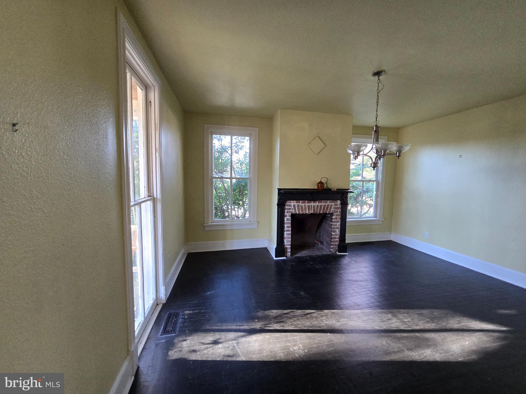 101 Chapel Road Easton, MD 21601 - Photo 20 of 35 a view of a livingroom with a fireplace wooden floor and a window