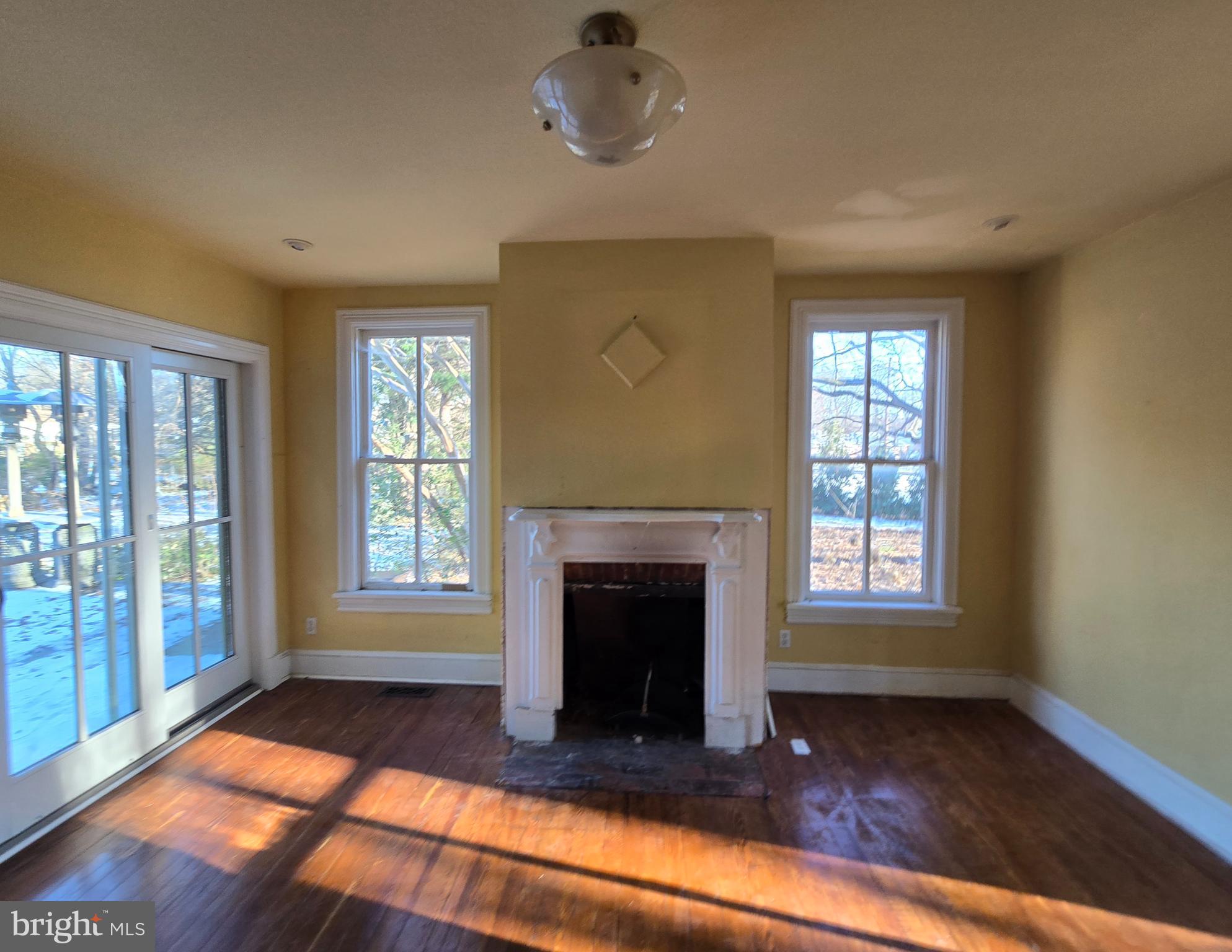 101 Chapel Road Easton, MD 21601 - Photo 24 of 35 a view of an empty room with exposed radiator and fireplace