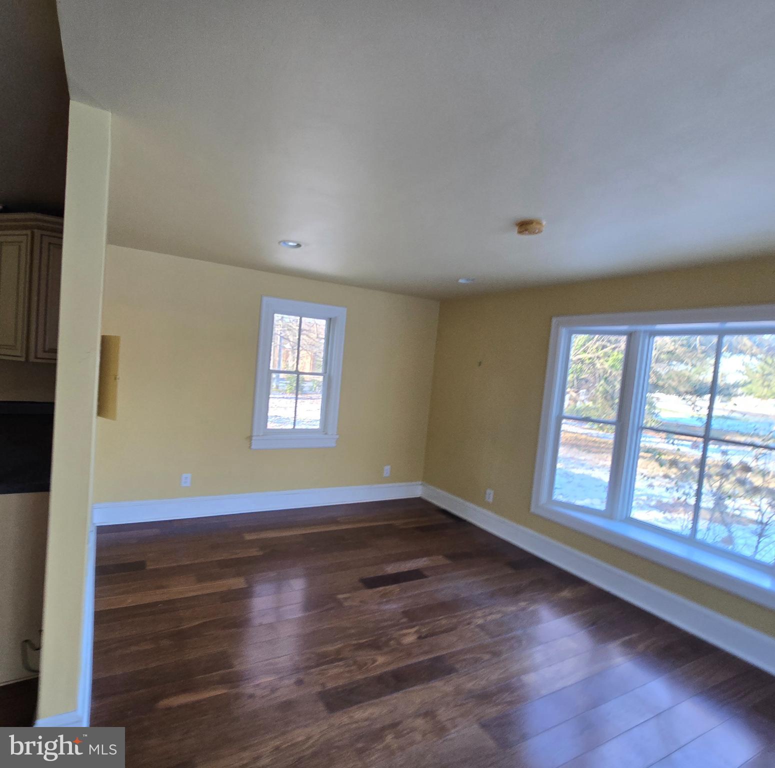 101 Chapel Road Easton, MD 21601 - Photo 32 of 35 an empty room with wooden floor and windows