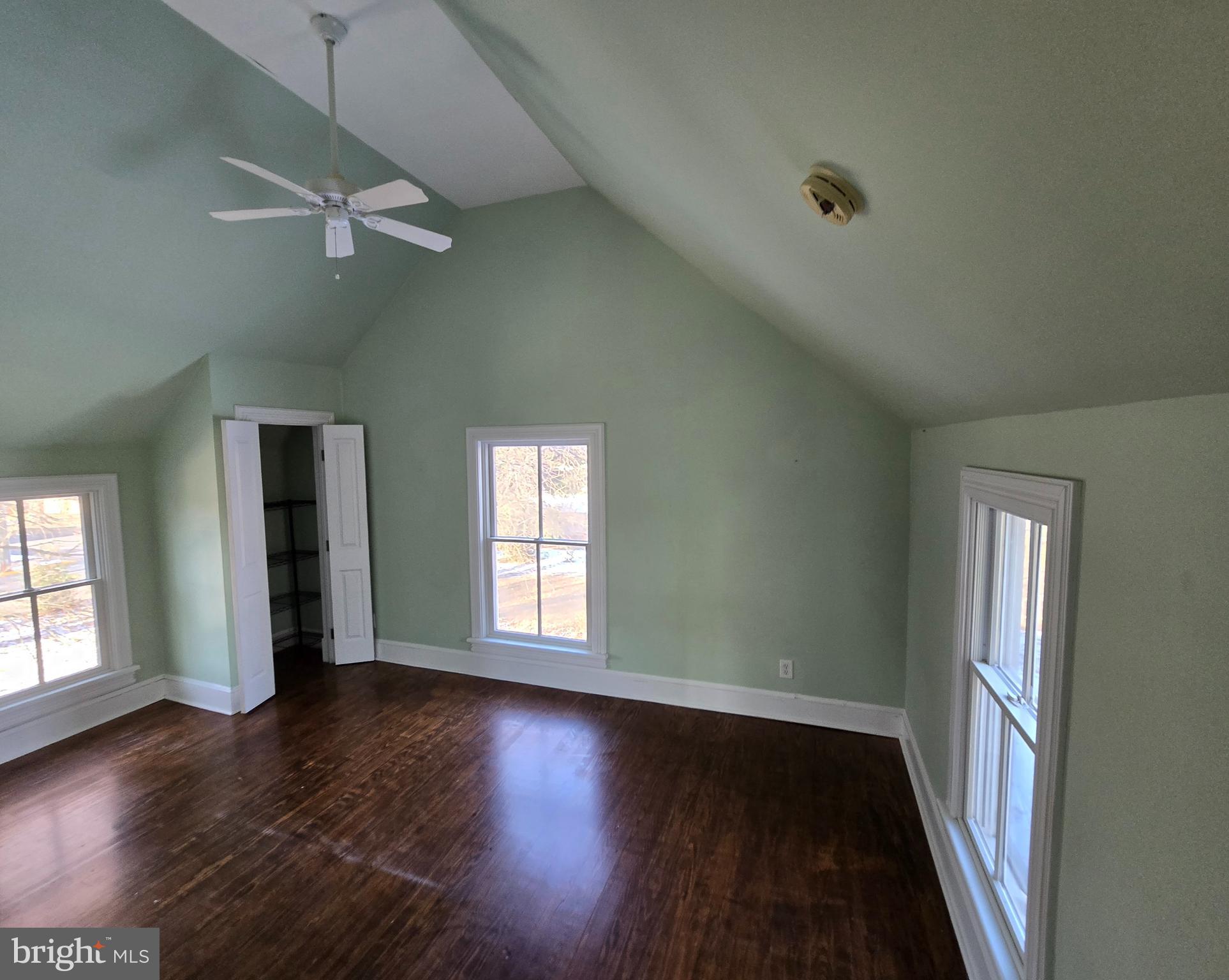 101 Chapel Road Easton, MD 21601 - Photo 6 of 35 an empty room with wooden floor and windows