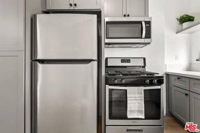 a kitchen with cabinets and stainless steel appliances