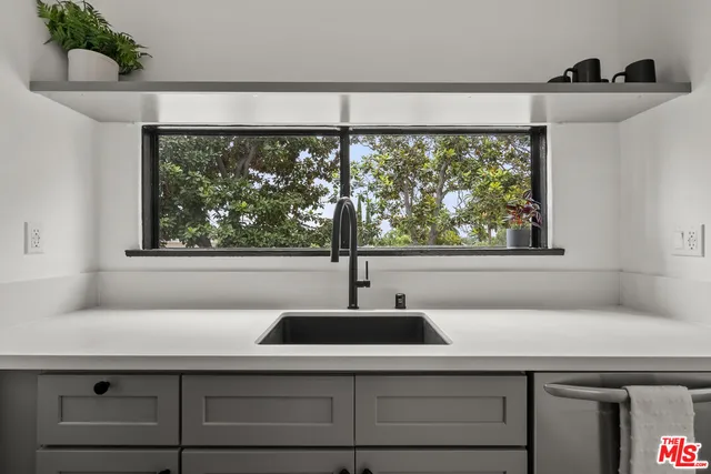 a bathroom with a sink and a window