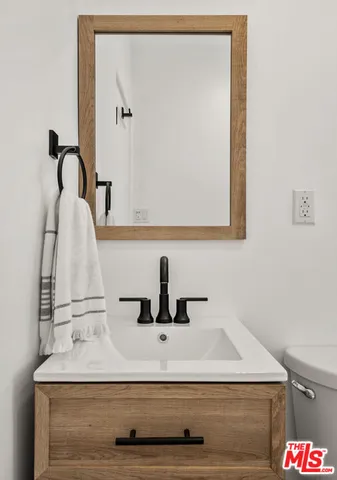 a bathroom with a sink and mirror