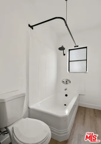 a bathroom with a toilet and a bathtub