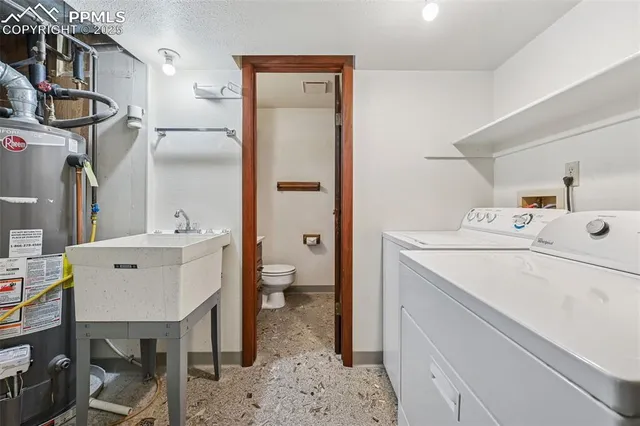 a utility room with cabinets washer and dryer