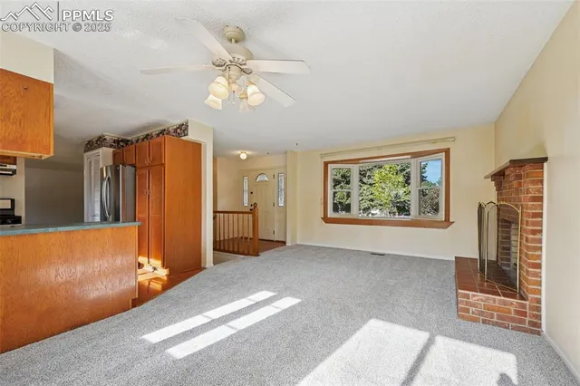 a view of livingroom with furniture and chandelier fan
