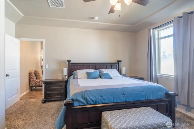 a bedroom with a bed and a chandelier