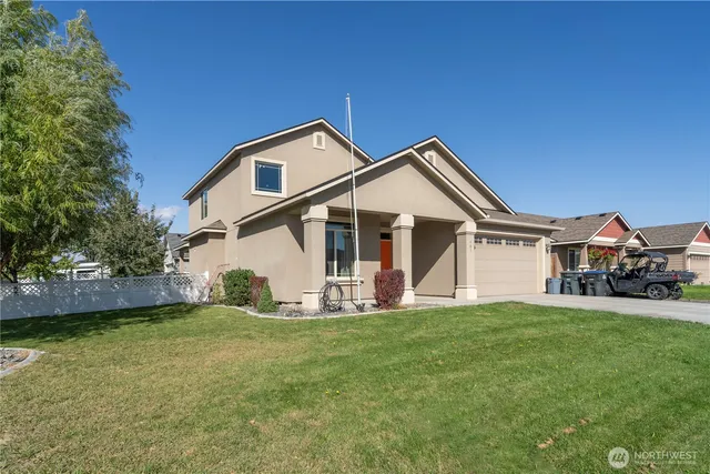 a front view of a house with a yard and porch