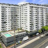 a view of a balcony with a couple of cars parked in front of it