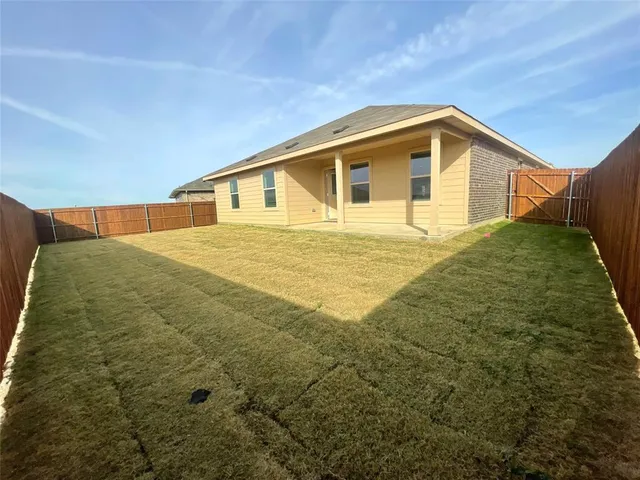 a big house with a big yard and large trees