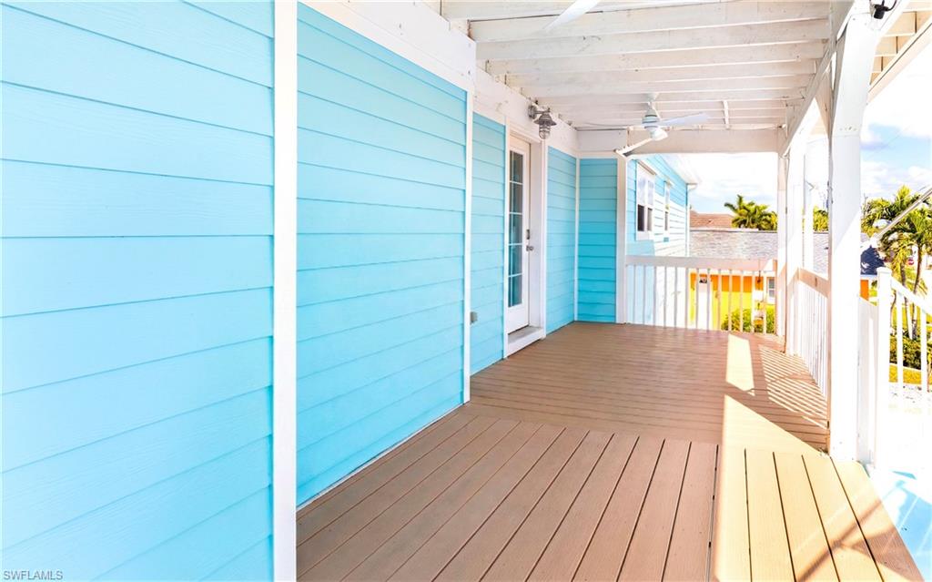 12277 Boat Shell Drive Matlacha Isles, FL 33991 - Photo 40 of 46 a view of a balcony with wooden floor and fence