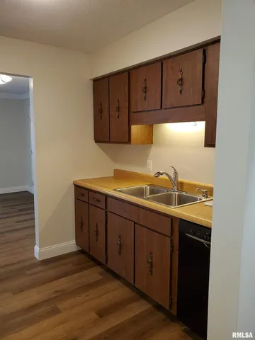 a view of a room with wooden floor and a cabinet
