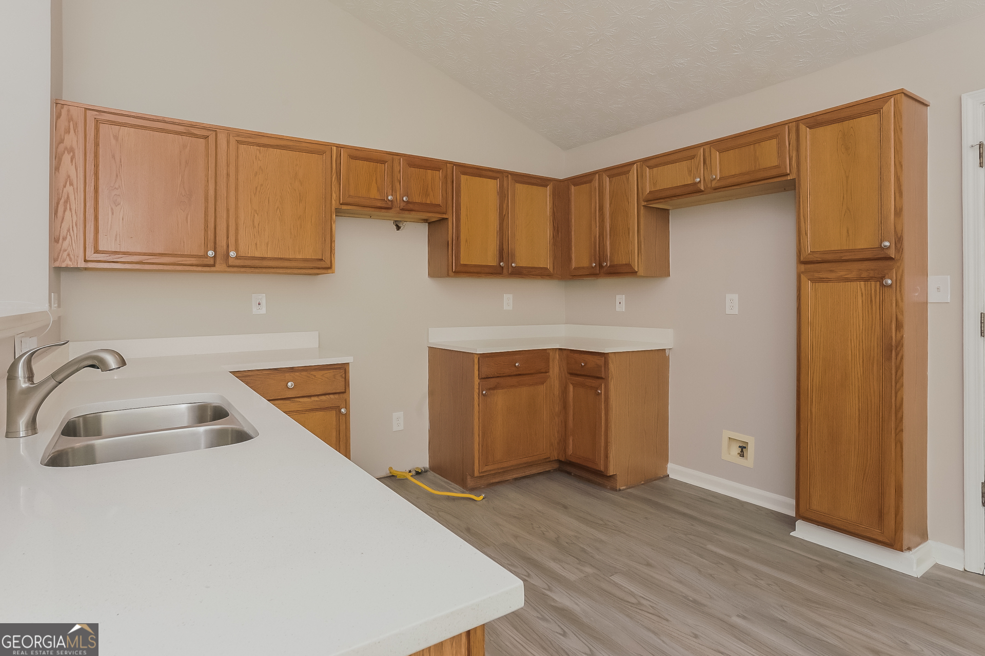 2983 Rapids Drive Decatur, GA 30034 - Photo 6 of 17 a kitchen with stainless steel appliances a sink dishwasher a refrigerator and cabinets with wooden floor