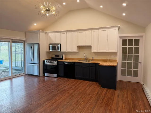 a kitchen with granite countertop stainless steel appliances and wooden cabinets