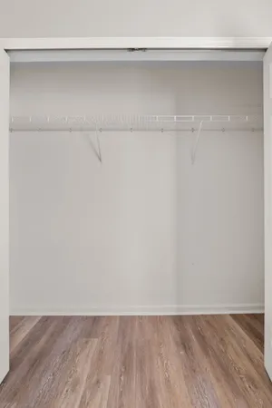 a view of a room with wooden floor