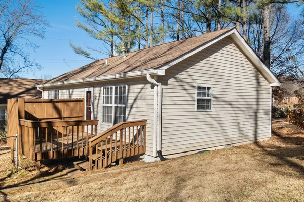 a view of a house with a yard and wooden fence