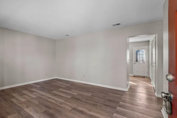 a view of a room with wooden floor