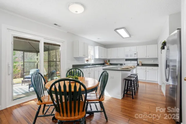 a dining room with furniture and wooden floor