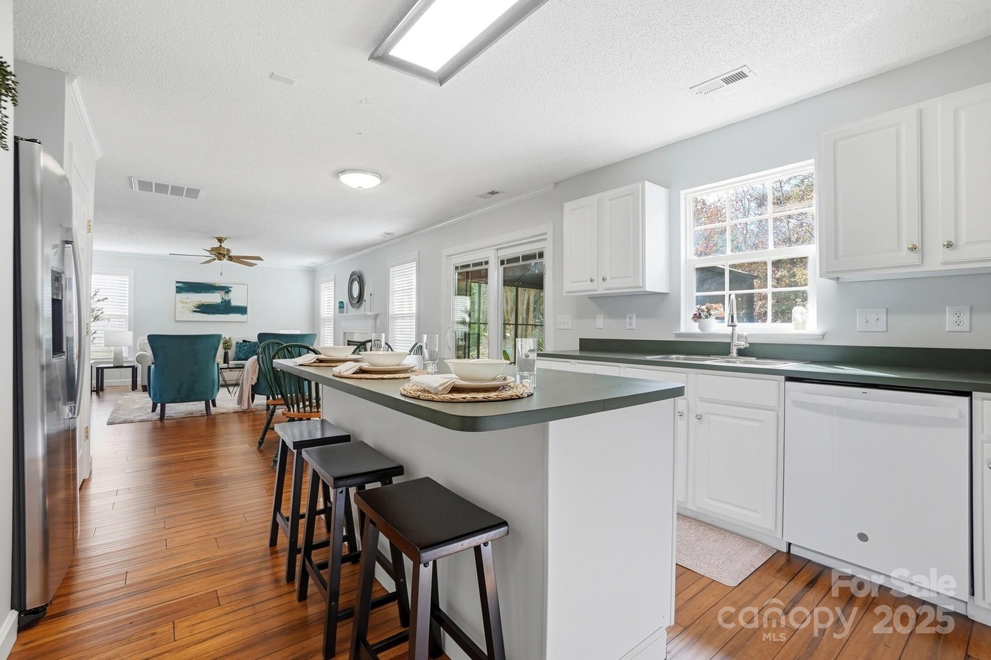 143 Amber Woods Drive Tega Cay, SC 29708 - Photo 16 of 46 a kitchen with counter top space and wooden floor