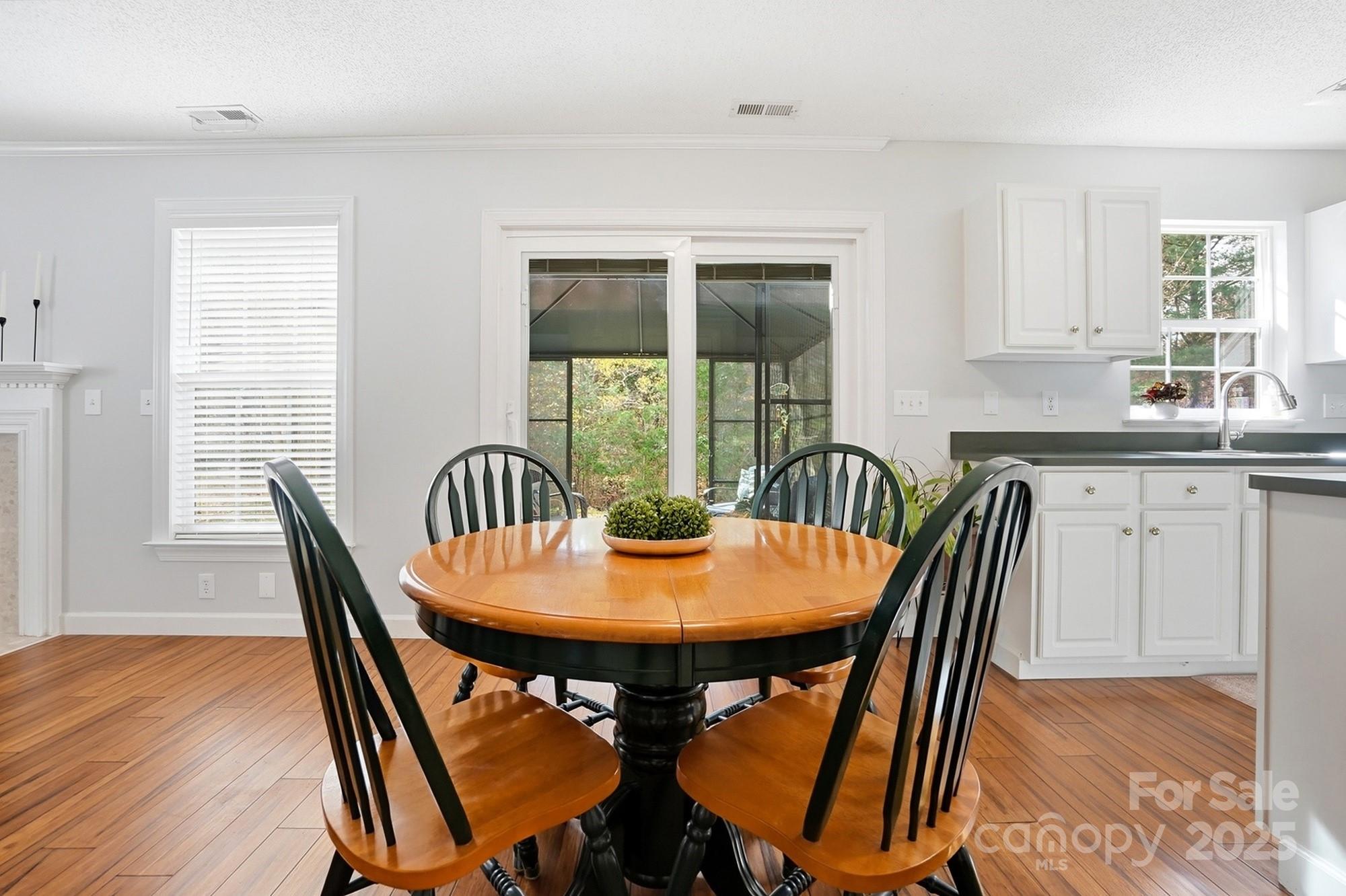 143 Amber Woods Drive Tega Cay, SC 29708 - Photo 17 of 46 a view of a dining room with furniture and wooden floor