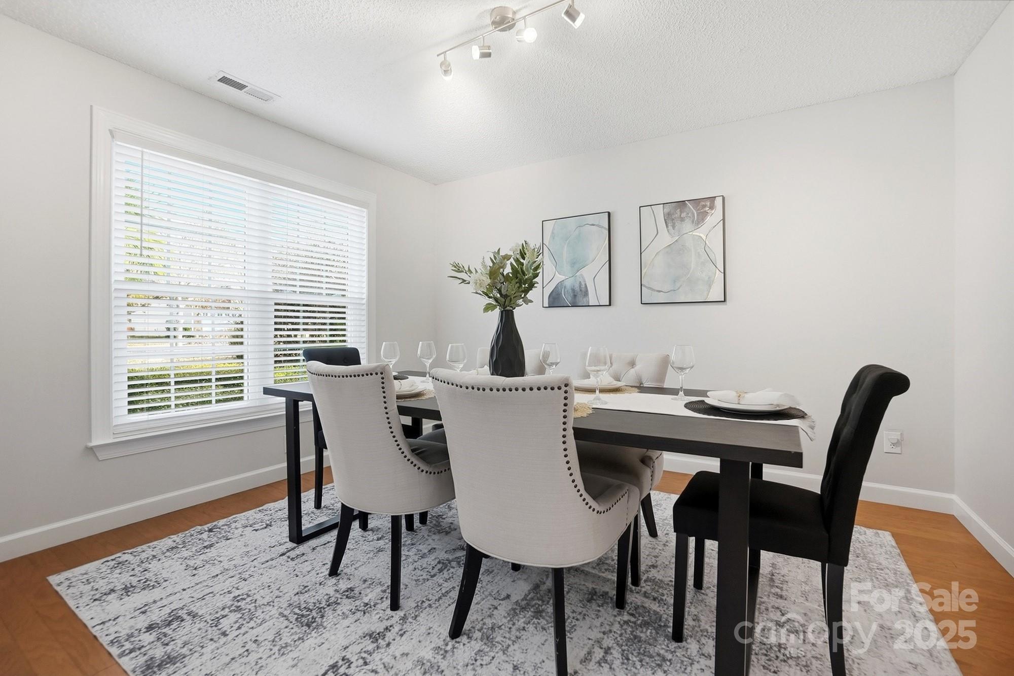 143 Amber Woods Drive Tega Cay, SC 29708 - Photo 18 of 46 a view of a dining room with furniture and wooden floor