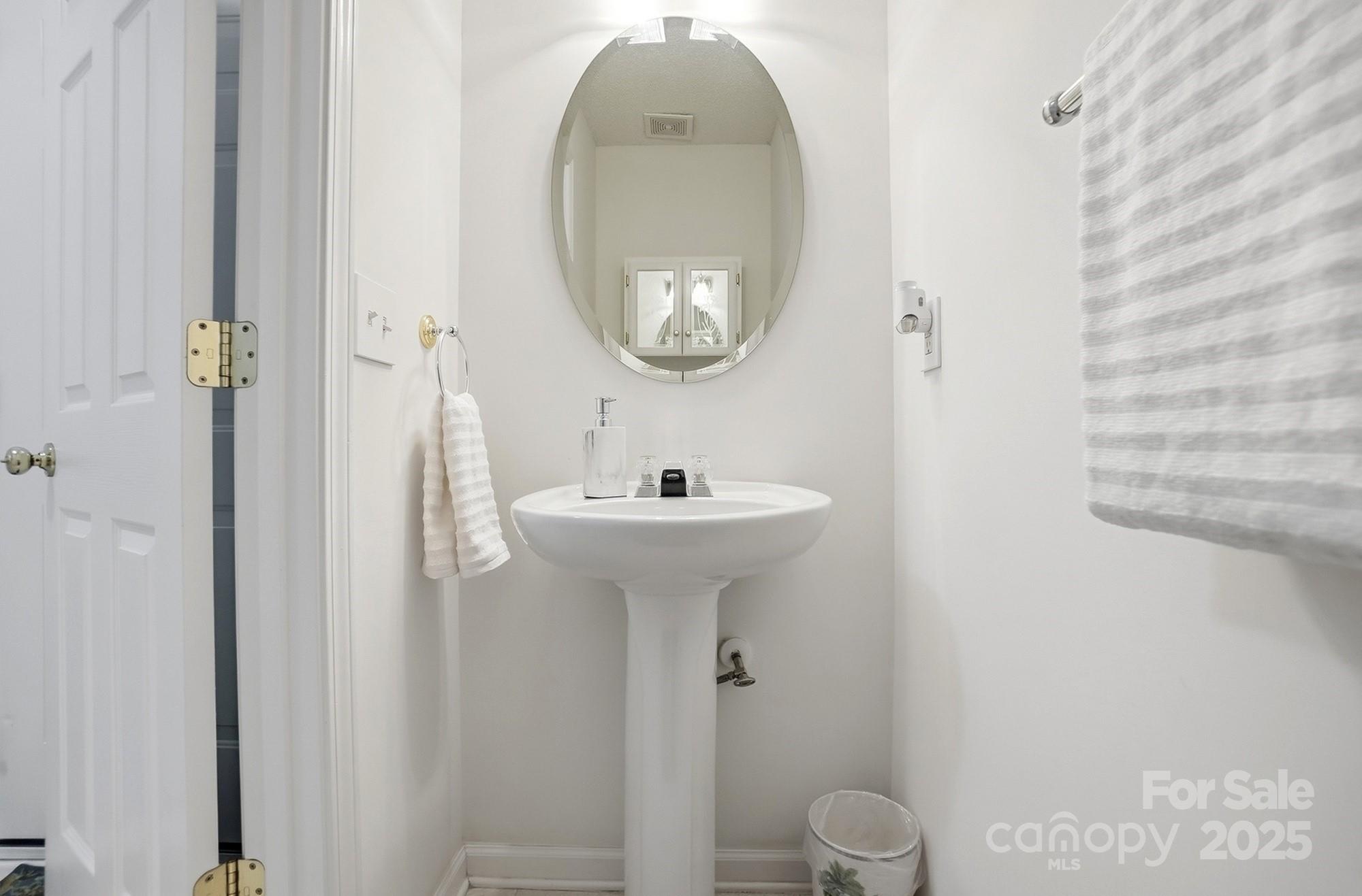143 Amber Woods Drive Tega Cay, SC 29708 - Photo 20 of 46 a bathroom with a sink a mirror and a toilet