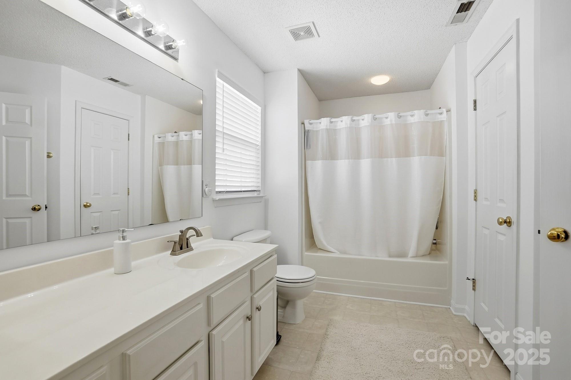 143 Amber Woods Drive Tega Cay, SC 29708 - Photo 28 of 46 a bathroom with a double vanity sink toilet and shower