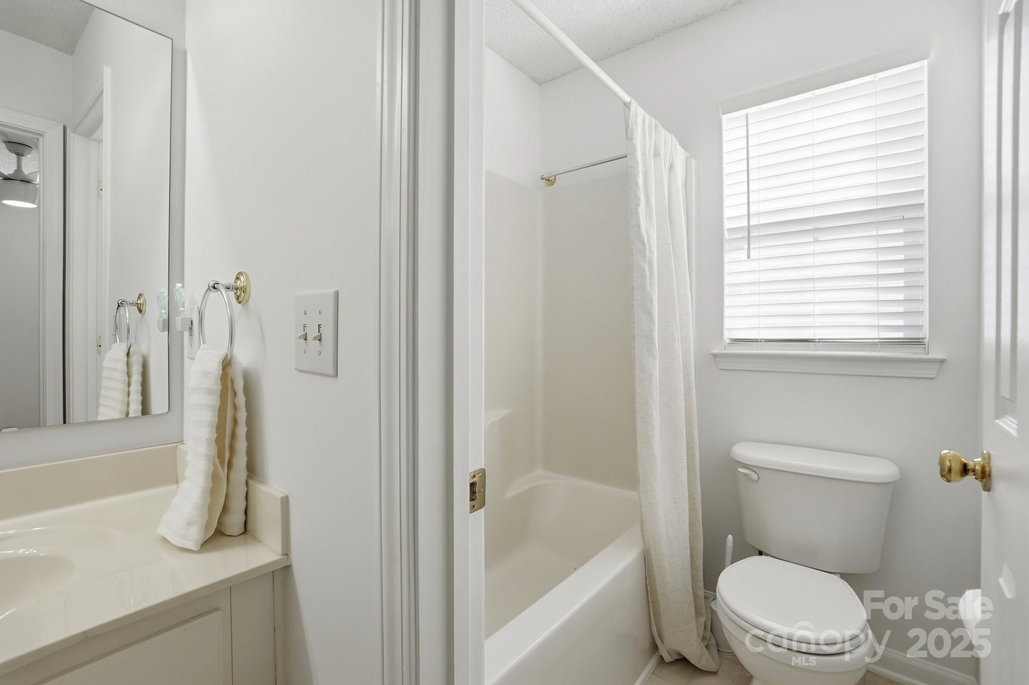 143 Amber Woods Drive Tega Cay, SC 29708 - Photo 34 of 46 a white toilet sitting next to a bath tub