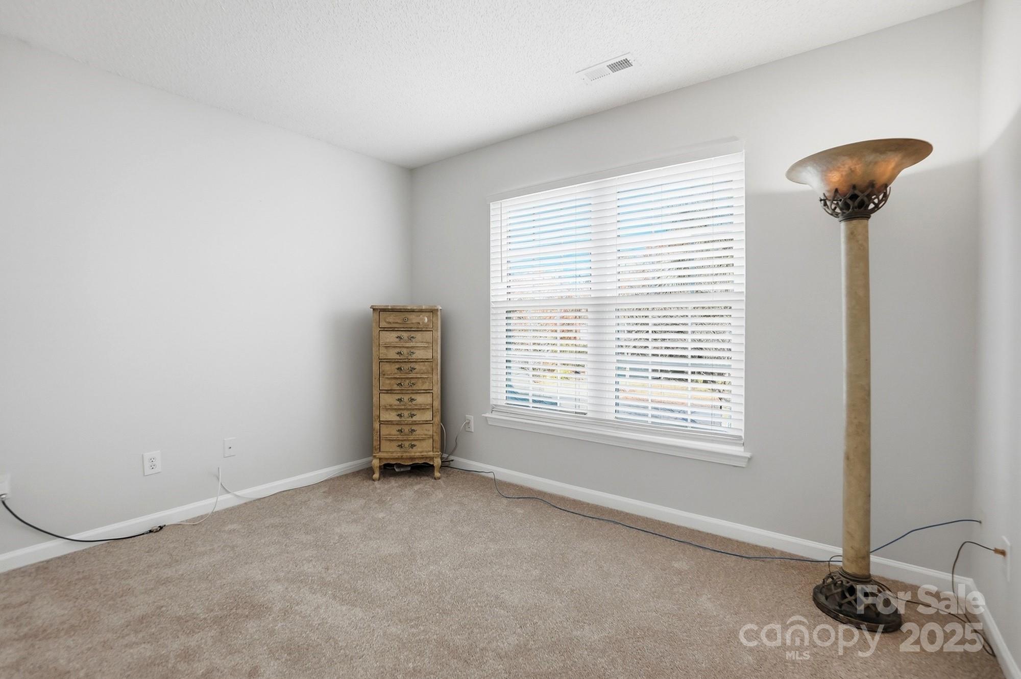 143 Amber Woods Drive Tega Cay, SC 29708 - Photo 36 of 46 a view of an empty room with a window