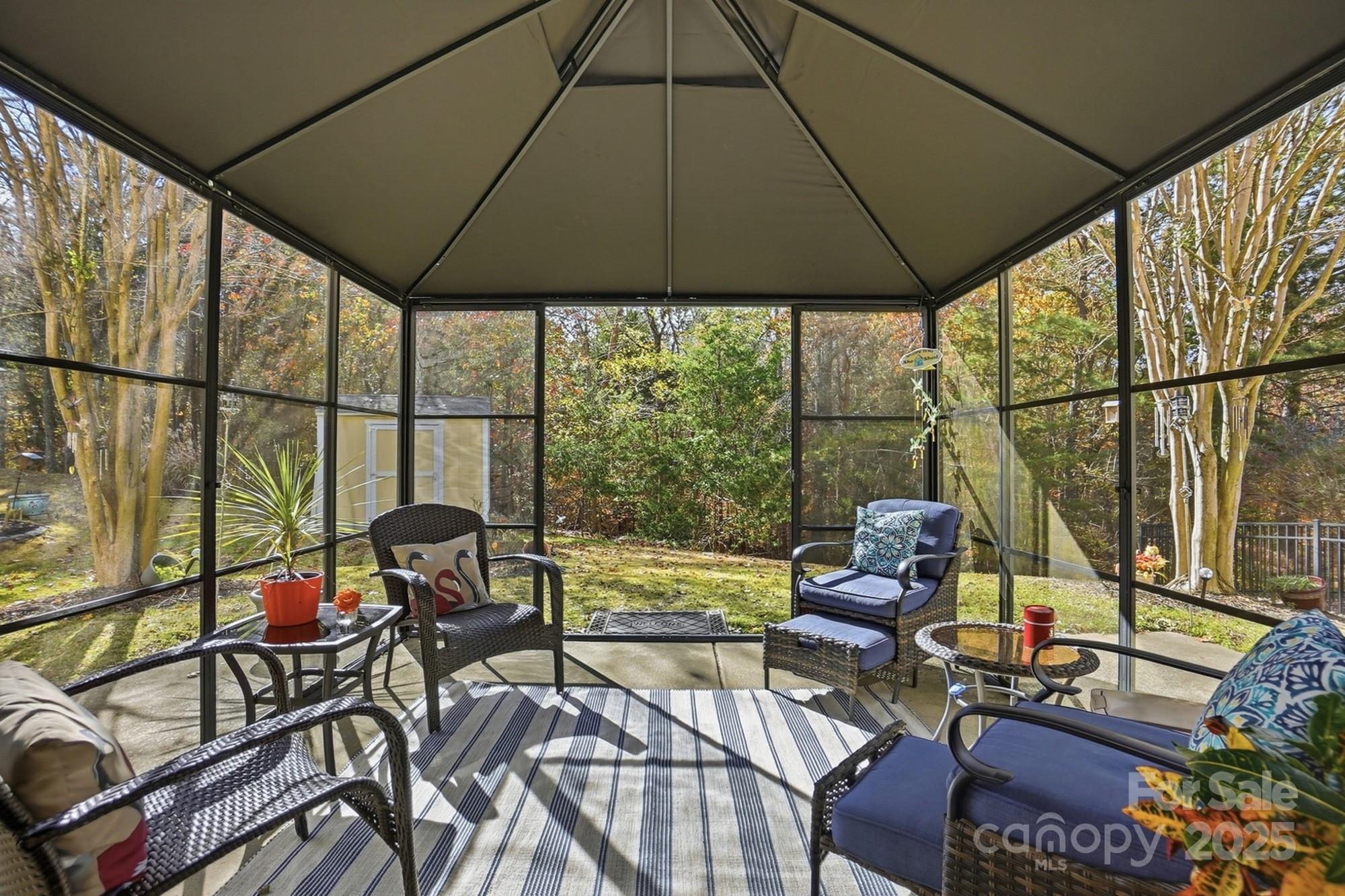 143 Amber Woods Drive Tega Cay, SC 29708 - Photo 38 of 46 a view of an outdoor sitting area with furniture and umbrella