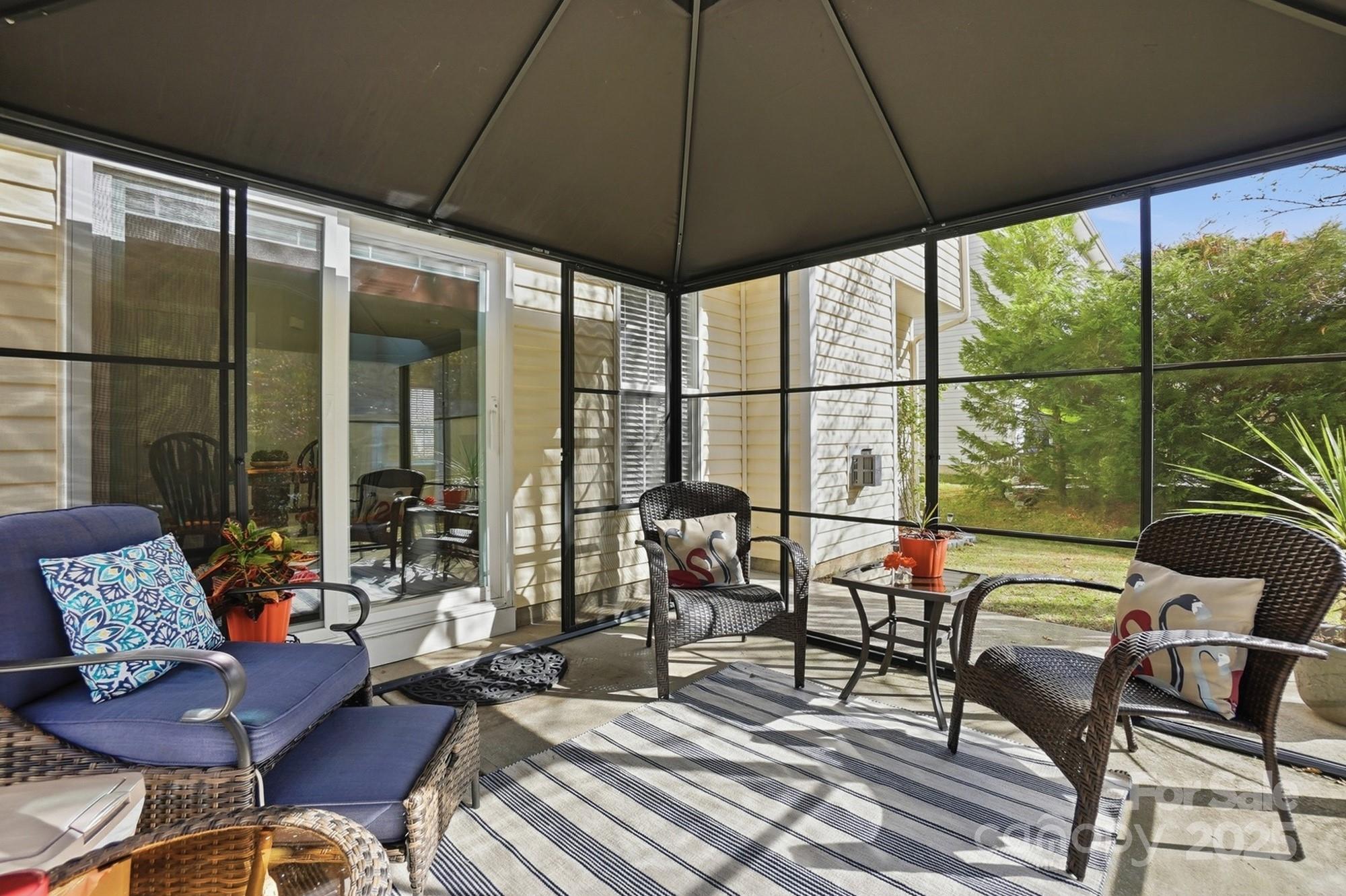 143 Amber Woods Drive Tega Cay, SC 29708 - Photo 40 of 46 a living room with furniture and a large window