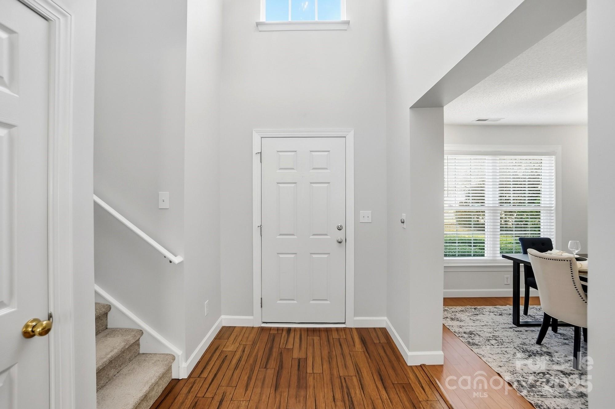 143 Amber Woods Drive Tega Cay, SC 29708 - Photo 4 of 46 a view of a livingroom with wooden floor and furniture
