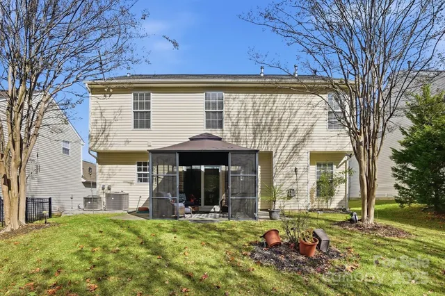 a view of a house with backyard porch and sitting area