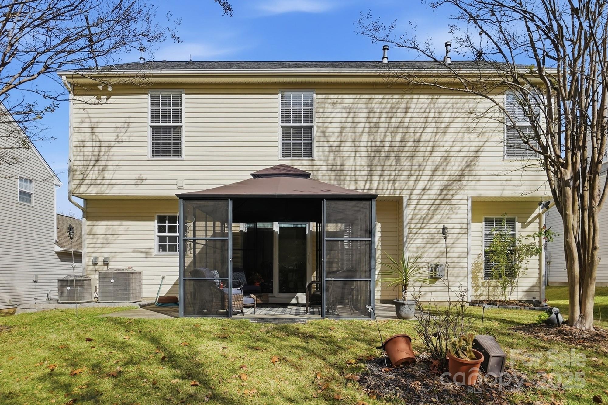 143 Amber Woods Drive Tega Cay, SC 29708 - Photo 44 of 46 a view of a house with backyard porch and sitting area