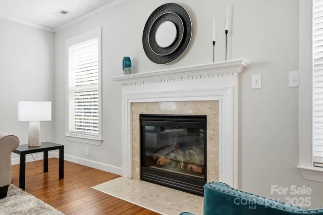 a living room with a fireplace and a window